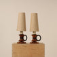 Pair circular handle table lamps, ebonized wooden rings