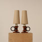 Pair circular handle table lamps, ebonized wooden rings